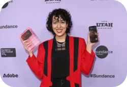Award winner at a press line holding an award..