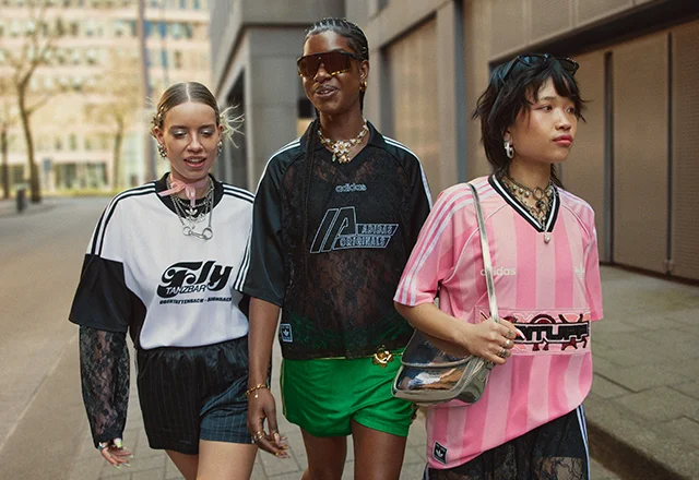 Three female models standing together, wearing adidas female soccer summer range including football shirts.