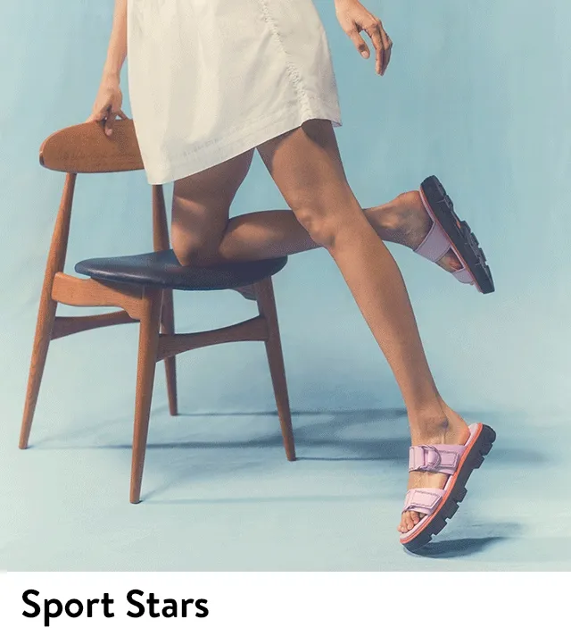A woman wearing purple slides.