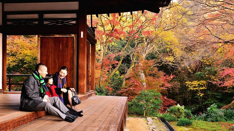 Image description: Family viewing autumn foliage in Kyoto.