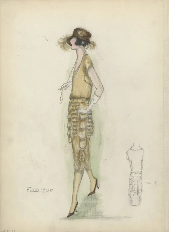 Gold knee-length dress; skirt with short tiers of ruffles, gathered at sides; bodice with scoop neck and short sleeves; narrow gold belt; brown cloche with brim on one side and brown feathers; a single strand of long beads; long white gloves