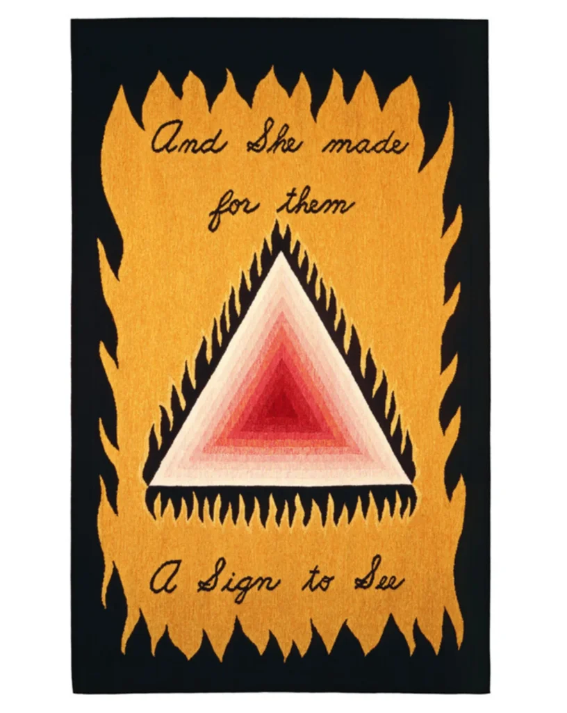A print of a banner that reads "And she made for them / A sign to see"