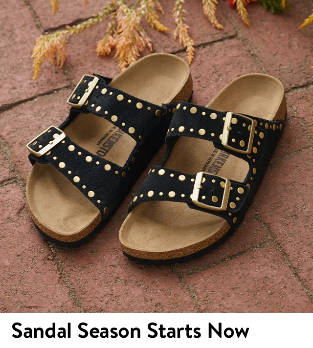 Black Birkenstock sandals with metal studs.