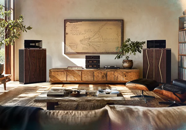80th Anniversary Klipschorn in the corner of a rustic living room next to wooden tv cabinet