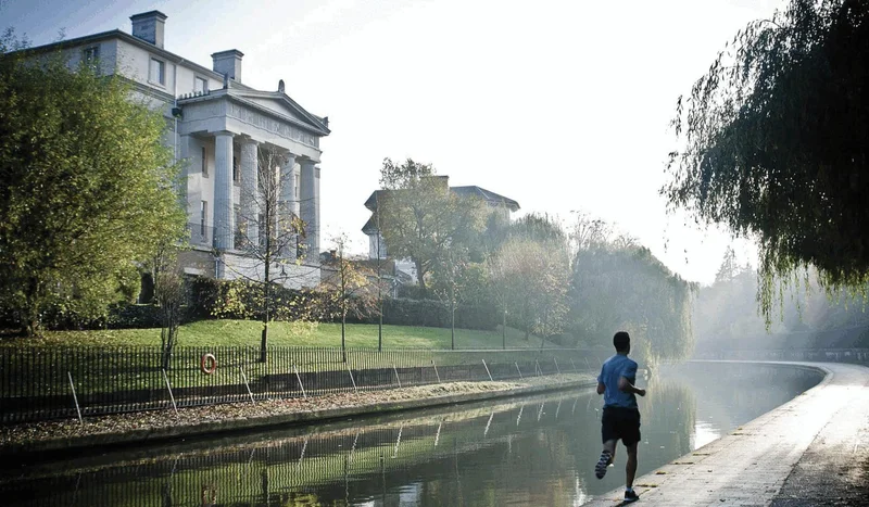 Image of man running next to canal at Regent's University