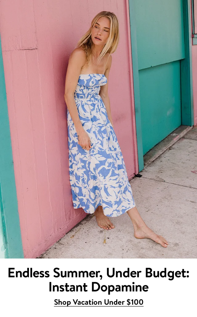 A woman wearing a strapless floral-print dress.