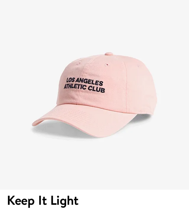 A pink baseball cap, beaded necklace, pink scarf and sunglasses.