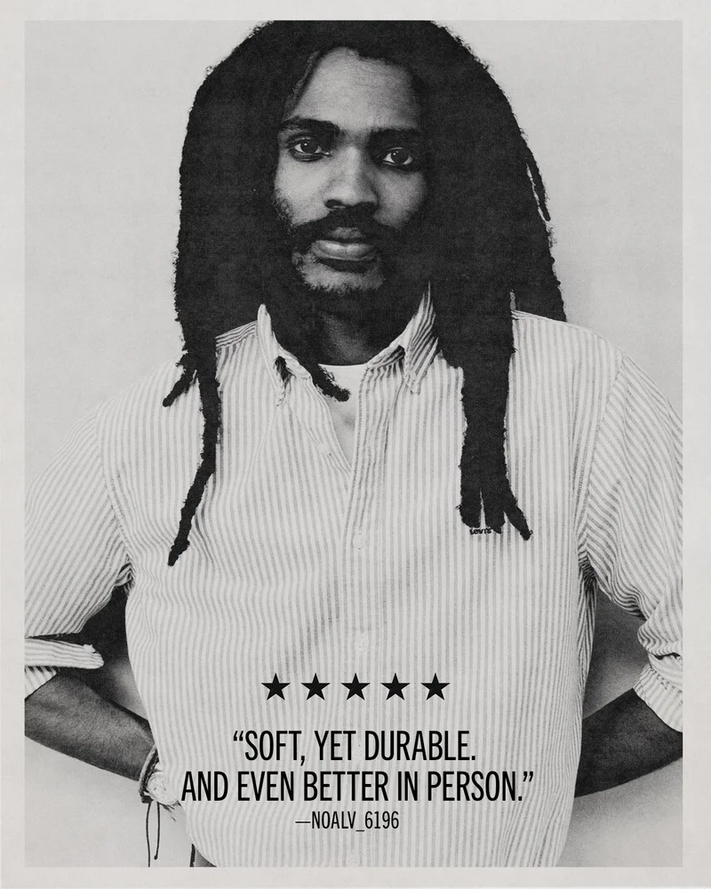 Black and white image of a man wearing a button up shirt