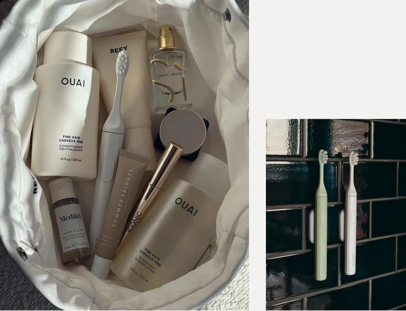 Sea Mist in a travel bag, a pair of SURI brushes mounted on the wall in a dark-tiled bathroom