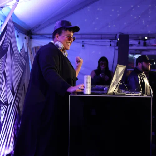 Image of a smiling person wearing headphones in a corporate atmosphere at the 2024 Sundance Film Festival.