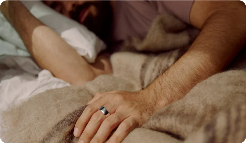 Person Wearing Oura Ring While Laying in Bed