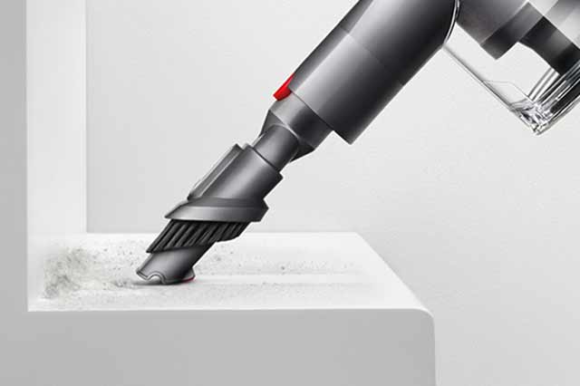The combinatino tool vacuuming a stair