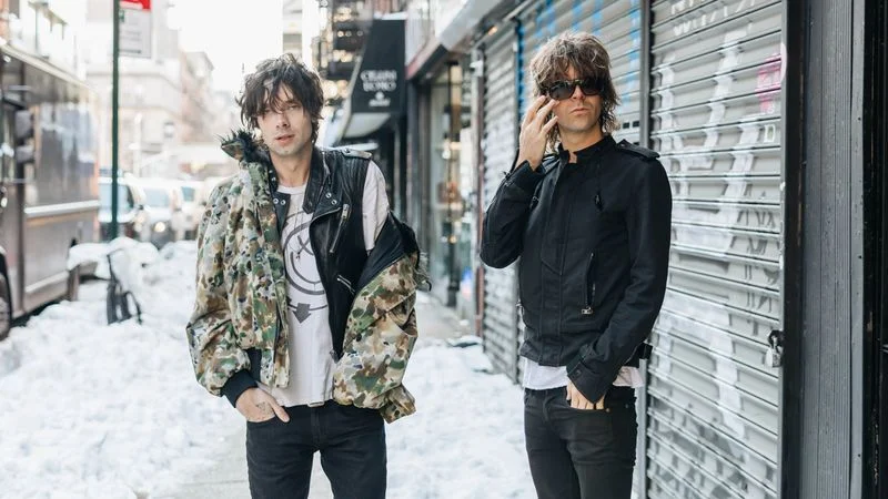 Image may contain: Gordon Moakes, Ryan Adams, Person, Teen, Clothing, Coat, Jacket, Pants, Adult, Pedestrian, and Footwear