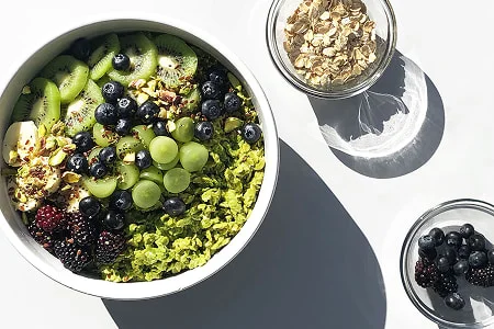 Green matcha oats topped with pistachios for a nutritious breakfast