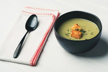Warm creamy probiotic soup served in a dark bowl