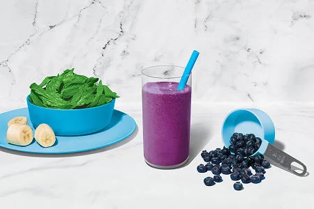 Blue smoothie made with berries and leafy greens for antioxidants and fiber