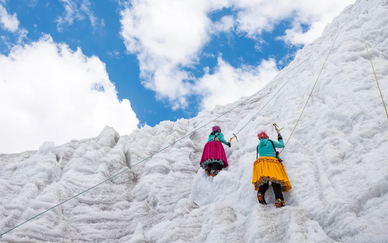Bolivia's cholitas climb Andean peaks in traditional polleras, voluminous pleated skirts.