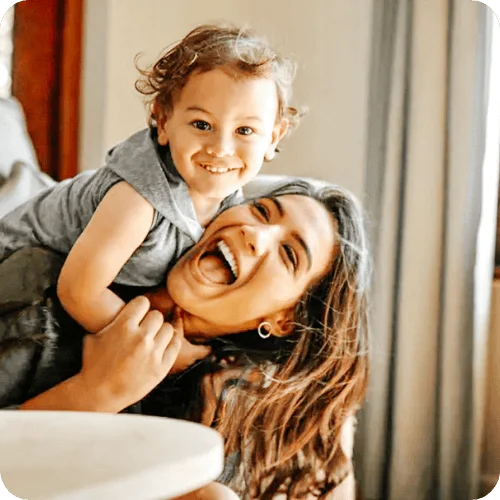 a mom playing with her toddler beaming because she listened to this amazing piece of mom advice a mom playing with her toddler beaming because she listened to this amazing piece of mom advice