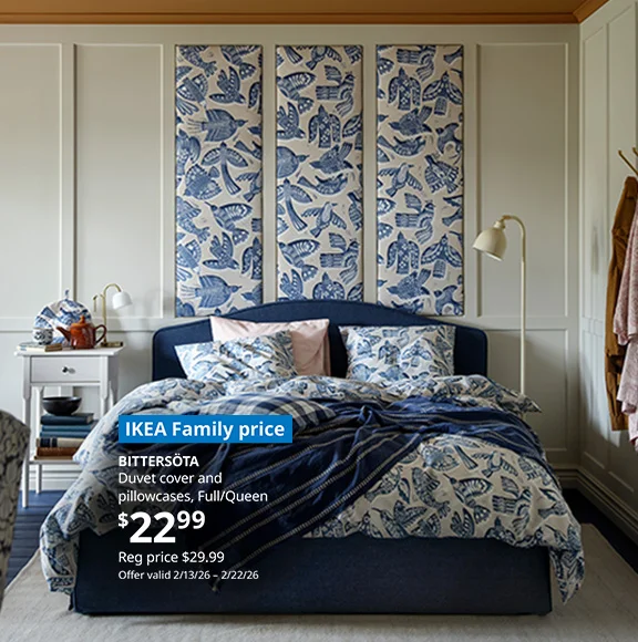 A bed dressed in the BITTERSOTA duvet cover and pillowcases which features lively, blue fluttering birds
