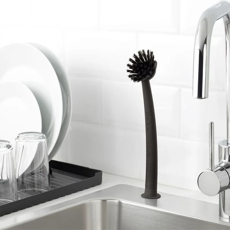 Black dish brush on sink.