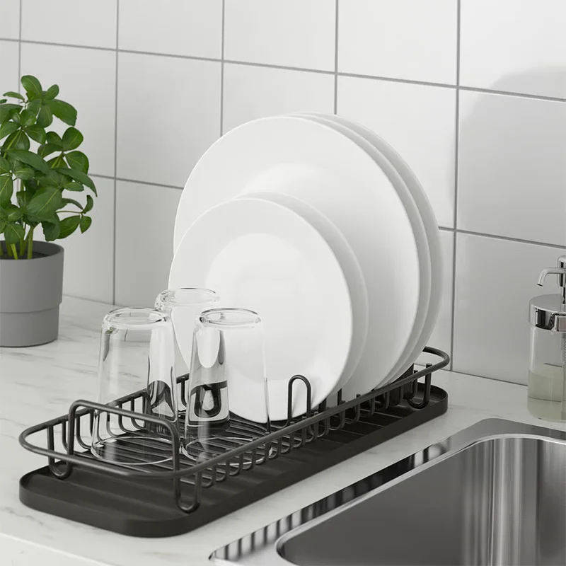 Black dish rack on sink.