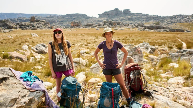Two travelers standing in the mountains.