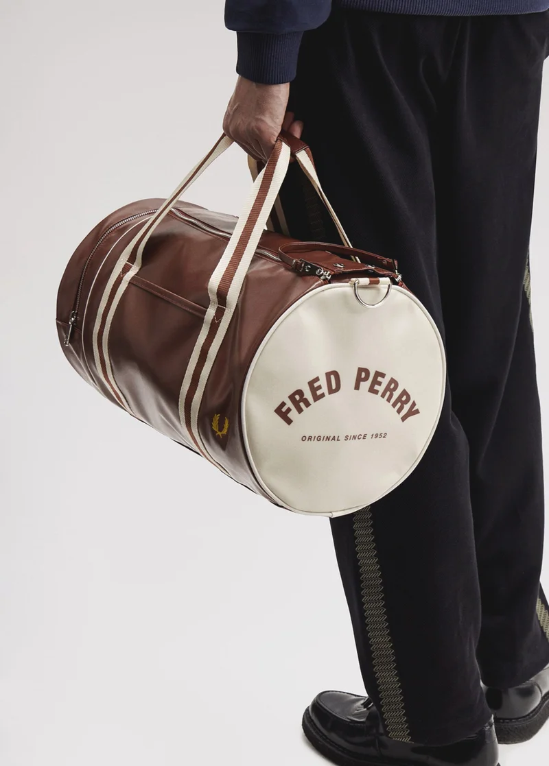 Model carrying a Fred Perry Barrel Bag in Tan / Ecru