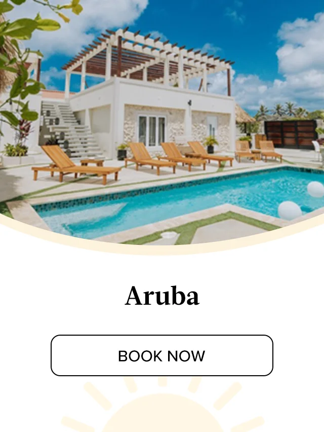 Lounge poolside in a breezy private villa just steps from the sand in Aruba.