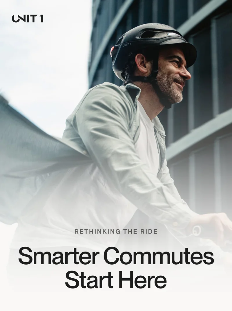 Man smiling while riding with a UNIT 1 smart helmet, representing a smarter, safer commute.