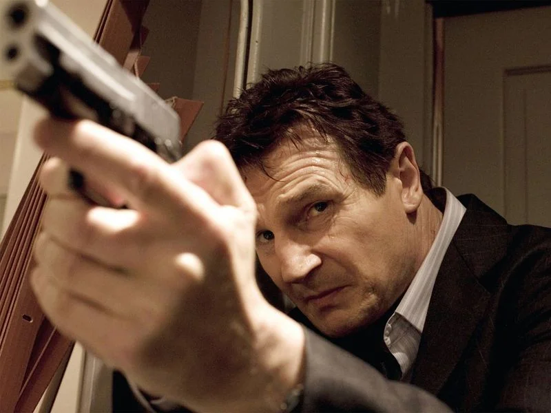 Image may contain: Liam Neeson, Firearm, Weapon, Gun, Adult, Person, Shooting, and Handgun