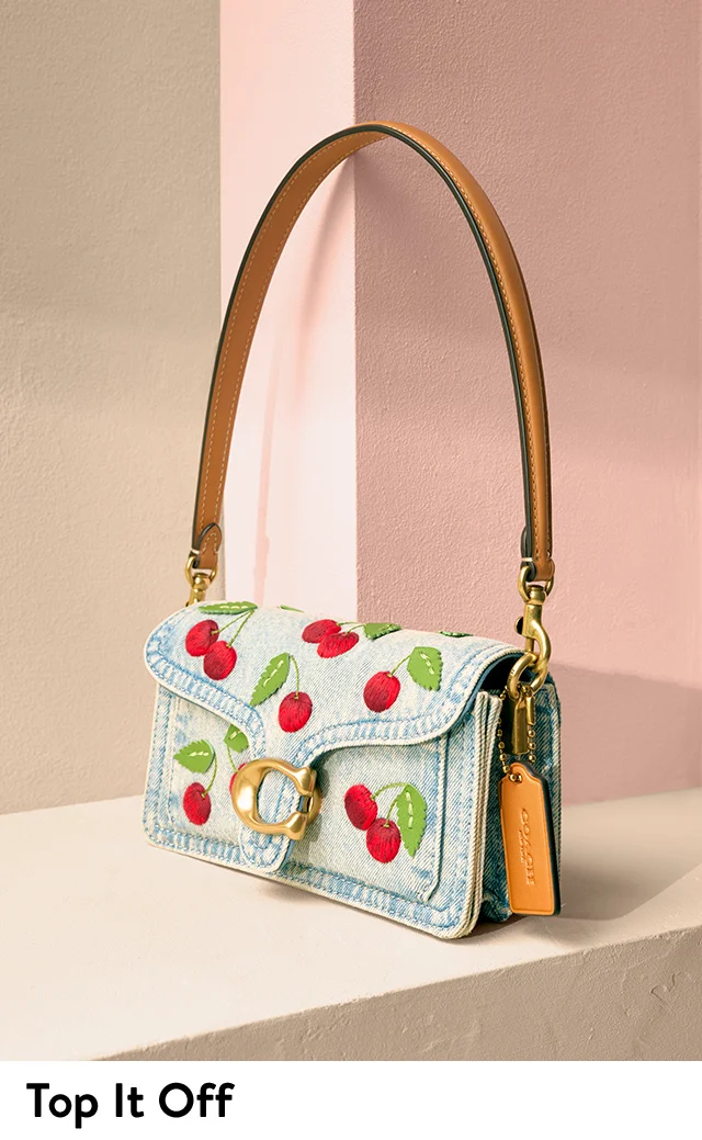 A shoulder bag with cherry embroidery.