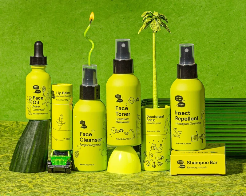 A collection of green bottled products with green random objects and a green background