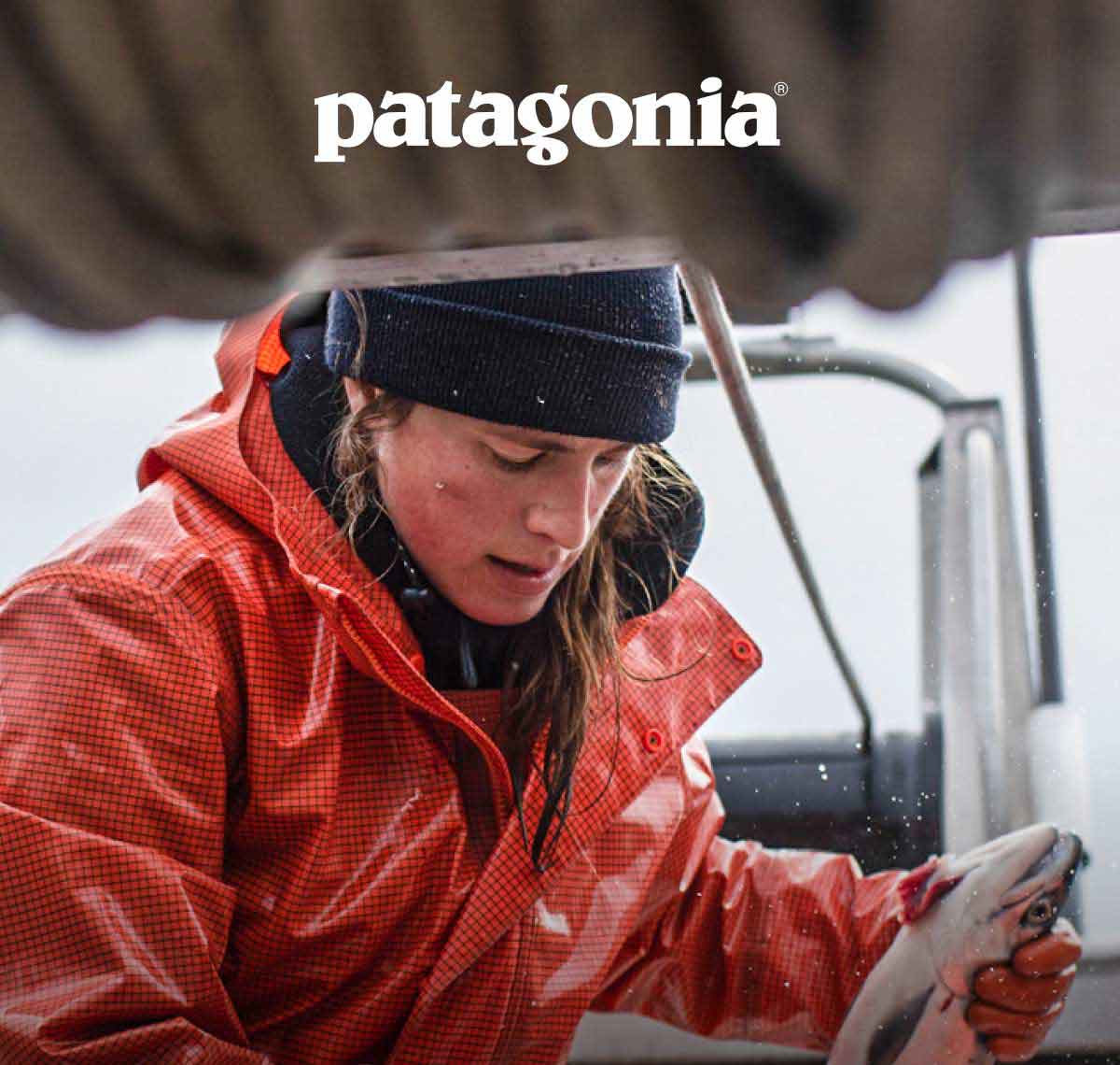 Patagonia. A person holding a fresh-caught fish on a boat.