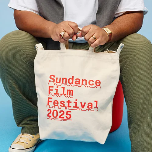 A model holds the 2025 Baggu tote in the color Natural.