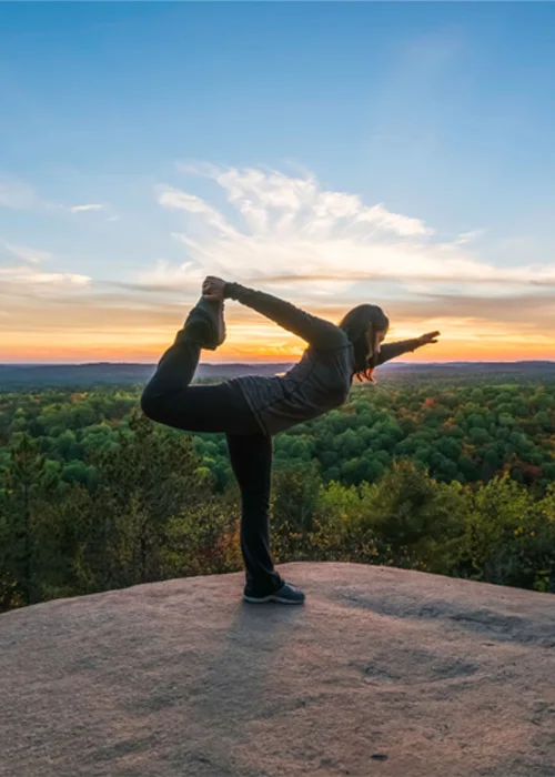 A young woman practices Pilates in Algonquin Park, Ontario, as the sun sets. Since their unlikely inception, the exercises have become a global phenomenon.