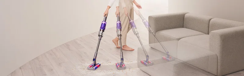 A woman cleaning hard floors with the Dyson Omni-Glide cordless vacuum