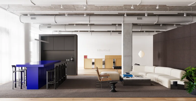 A room with a blue Datesweiser high-top table on the left with stools on either side next to a low lounge on the right with a Knoll D'Urso Coffee Table in Chrome, Geiger Sled Chairs in tan leather, and a cream Muuto Connect Modular Sofa.