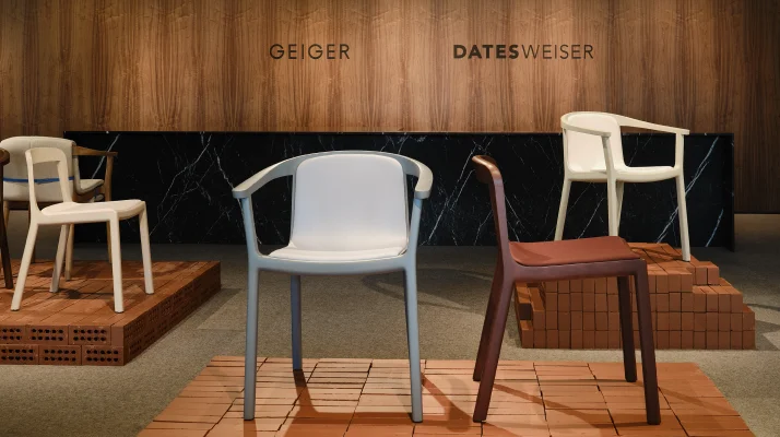 Lijn Side and Armchairs designed by Carole Baijings for Geiger in assorted finishes shown front-facing on an exhibition platform in the Geiger DatesWeiser showroom in Chicago