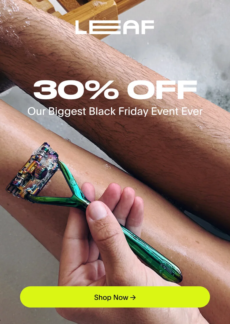 Person holding a leaf razor against one shaved leg