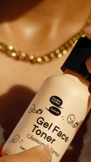 A Brown person applies creamy gel toner to their face.