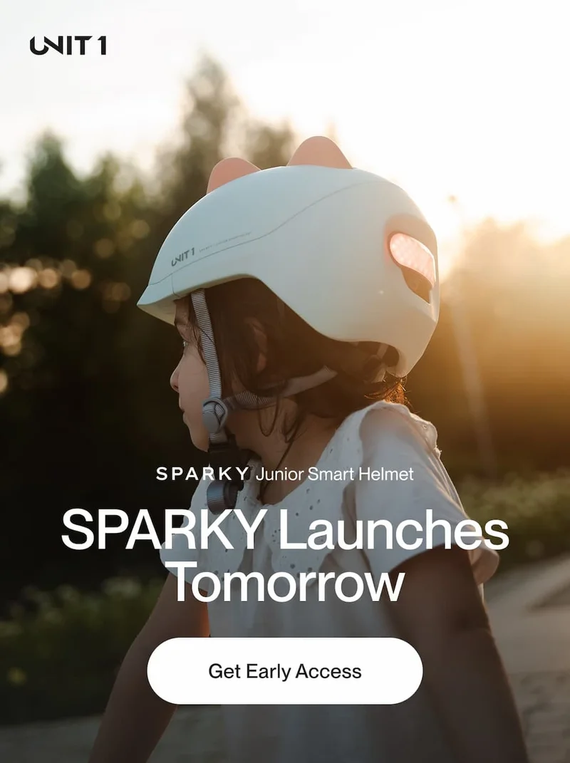 Young child wearing the blue SPARKY Junior Smart Helmet by UNIT 1, outdoors with the text 'Sparky Launches Tomorrow'.