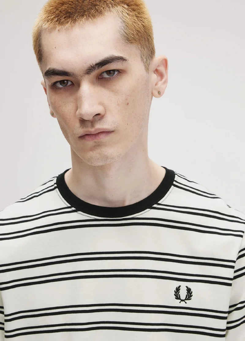Person wearing Fred Perry white & black striped t-shirt