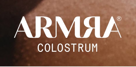 ARMRA Colostrum logo on a smooth brown background.