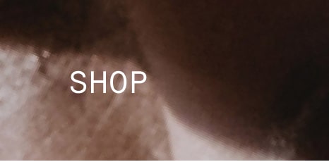 Text ‘SHOP’ over a close-up textured brown background.