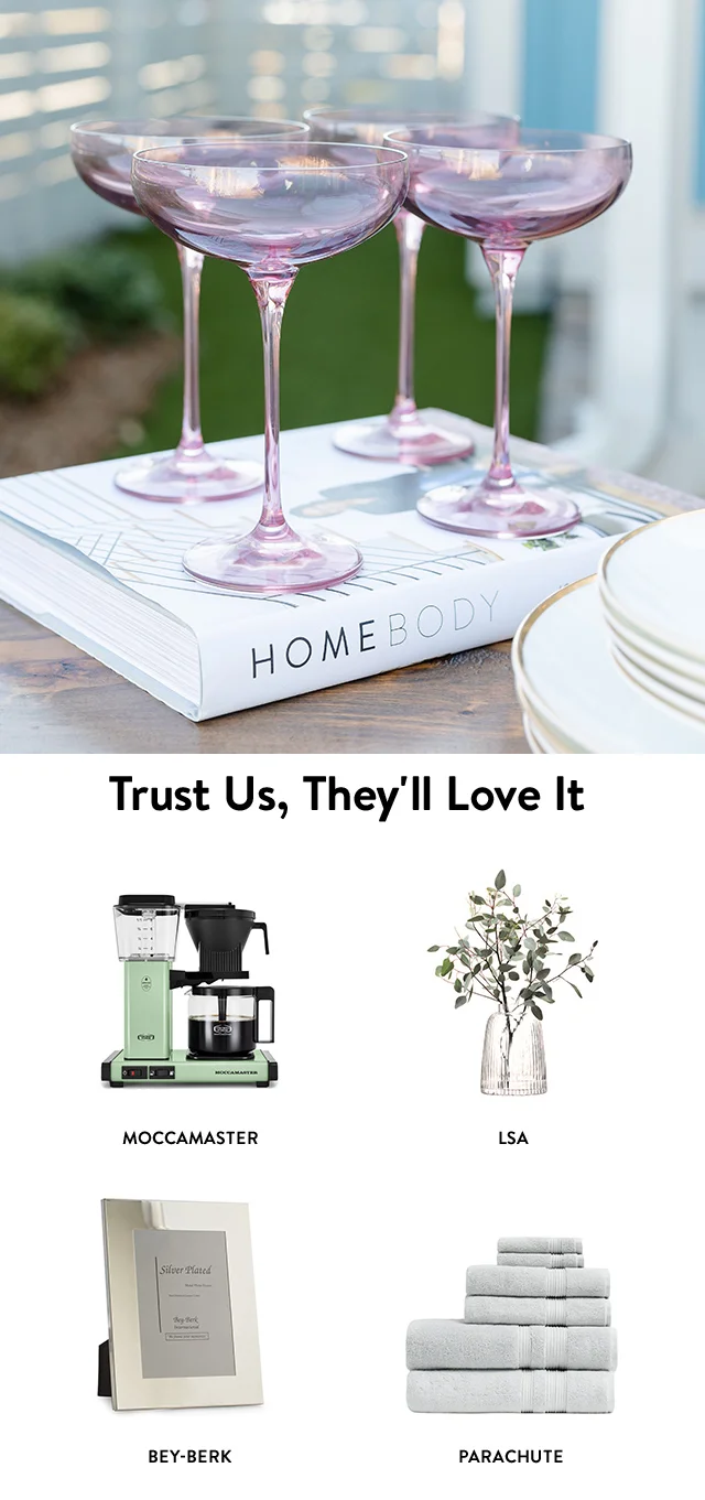 A set of lavender stem coupes. A coffee brewer, glass vase, picture frame and stack of bath towels.