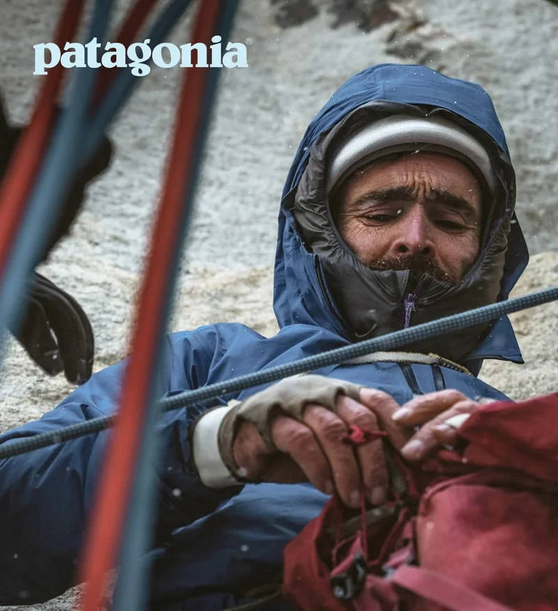 Patagonia. A climber in the rain opens their backpack.