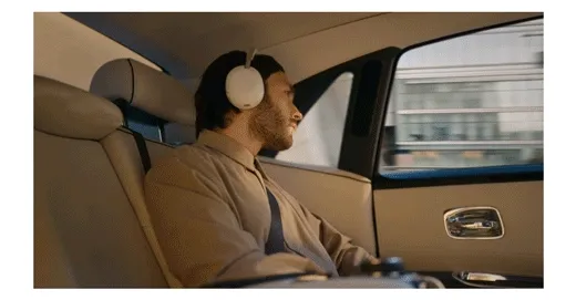 Animated GIF of a man in a luxury car listening to music with The 1000X Collection headphones.