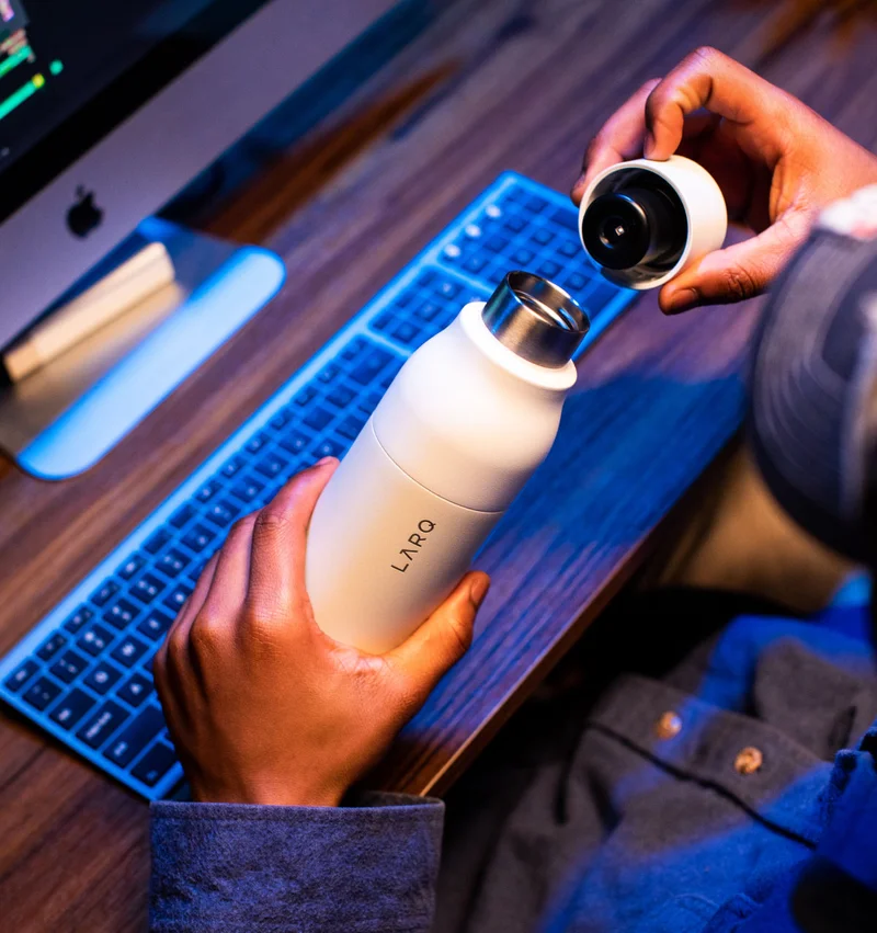 man holding  LARQ Bottle PureVis™  opened up to show the inside of the lid