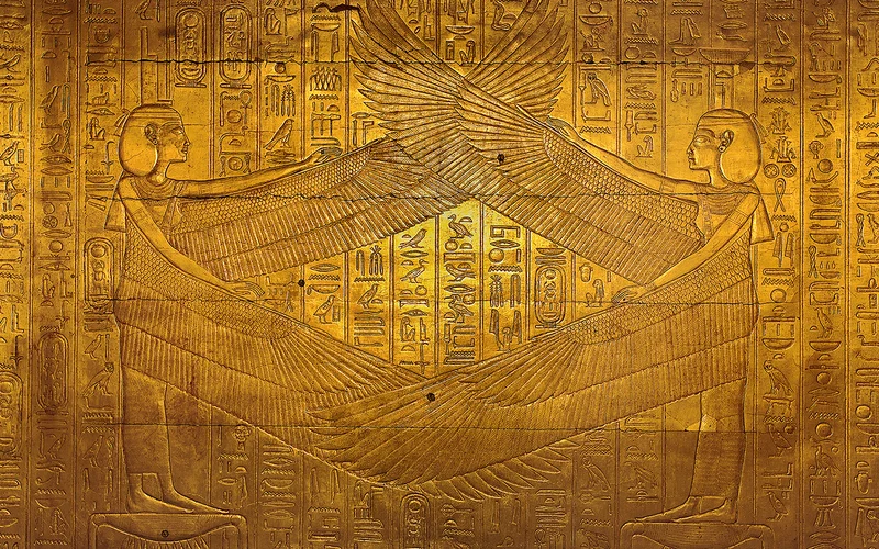 Spreading their wings in protection, the goddesses Isis (left) and Nephthys (right) are surrounded by sacred texts in the third golden shrine of the tomb of Pharaoh Tutankhamun, Valley of the Kings. Egyptian Museum, Cairo.
