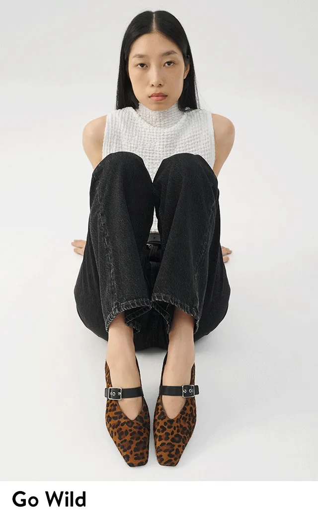 A model wearing leopard-print flats.